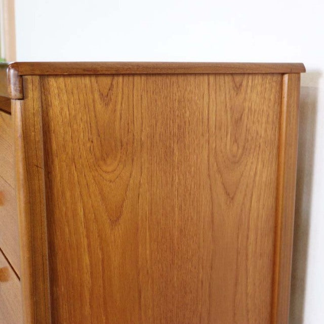 Mid-century British vintage teak sideboard by Nathan with smooth wood grain and rounded edges.
