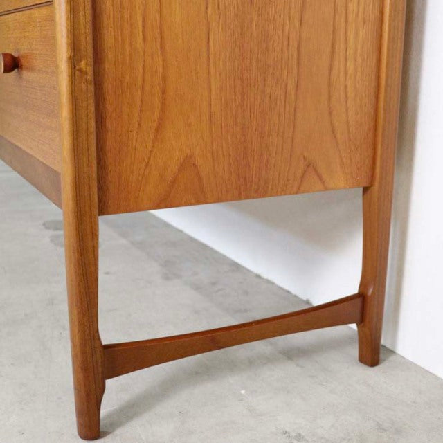 Mid-century British vintage teak sideboard leg with smooth wood grain and tapered support brace.