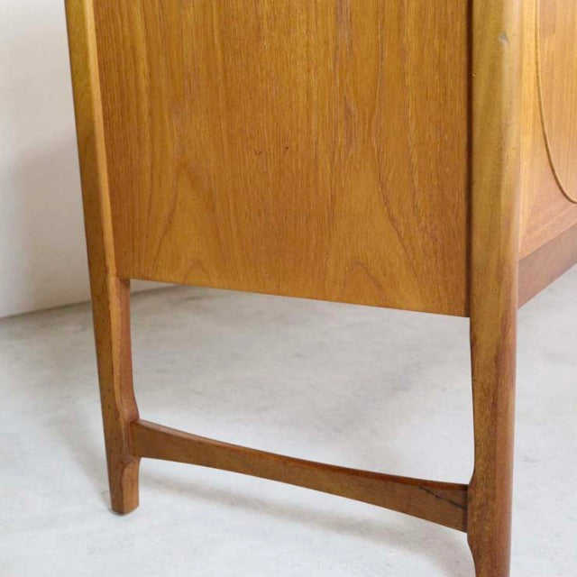 Vintage British mid-century teak sideboard leg detail with smooth wood grain and tapered design.