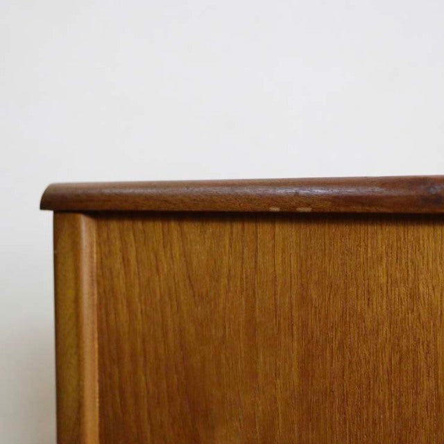 Mid-century British Nathan vintage sideboard corner in rich teak with smooth wood grain and rounded edge detail.