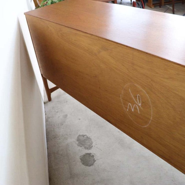 Mid-century British vintage teak sideboard by Nathan, smooth wood grain, slender legs, warm honey tone, Danish design.