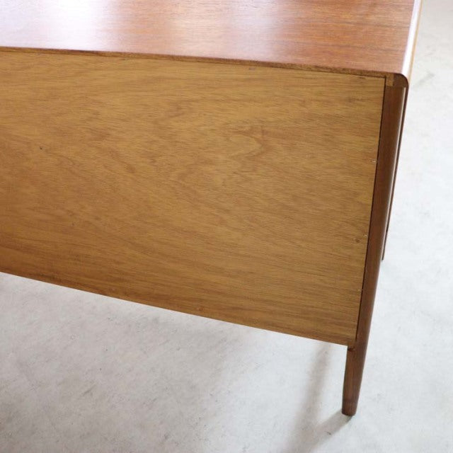 Mid-century British vintage teak sideboard corner with smooth wood grain and tapered leg detail from Nathan furniture.