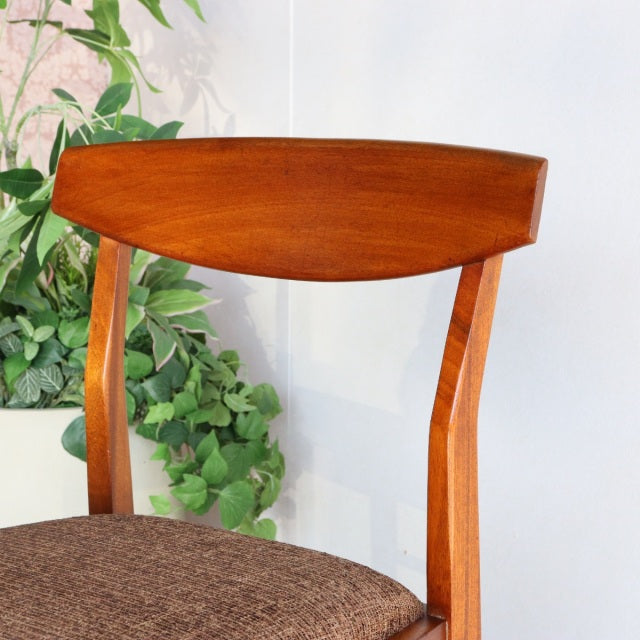 Mid-century vintage teak dining chair by British McIntosh, smooth curved backrest, angled legs, brown upholstered seat.