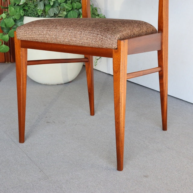 Mid-century British teak dining chair by McIntosh with tapered legs and textured brown upholstered seat.