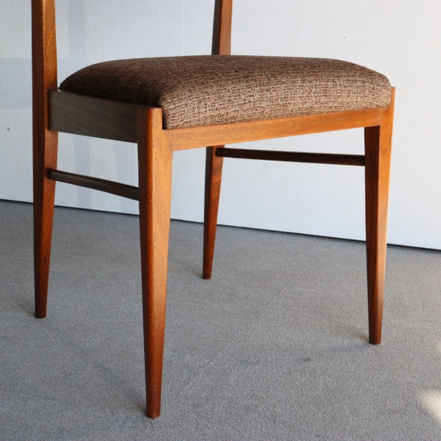 McIntosh vintage mid-century teak dining chair from Denmark with tapered legs and textured brown upholstered seat.