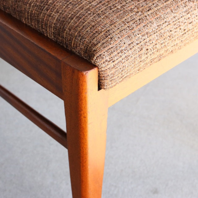 Mid-century British vintage McIntosh dining chair with teak wood frame and textured brown fabric seat.