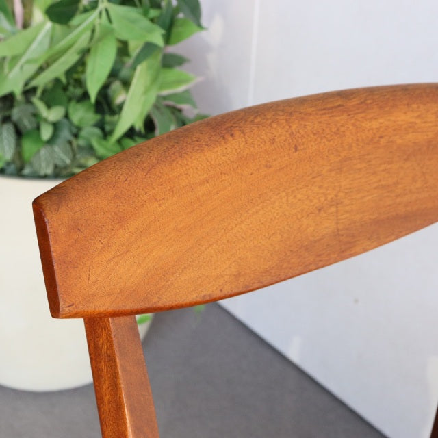 Mid-century British McIntosh dining chair with curved teak backrest and visible wood grain, classic vintage design from.