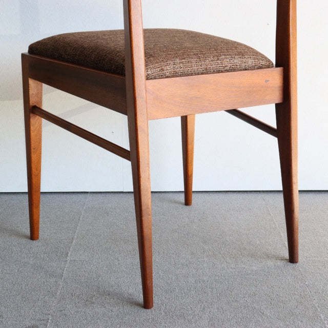 Mid-century British teak dining chair by McIntosh with tapered legs and textured brown upholstery.