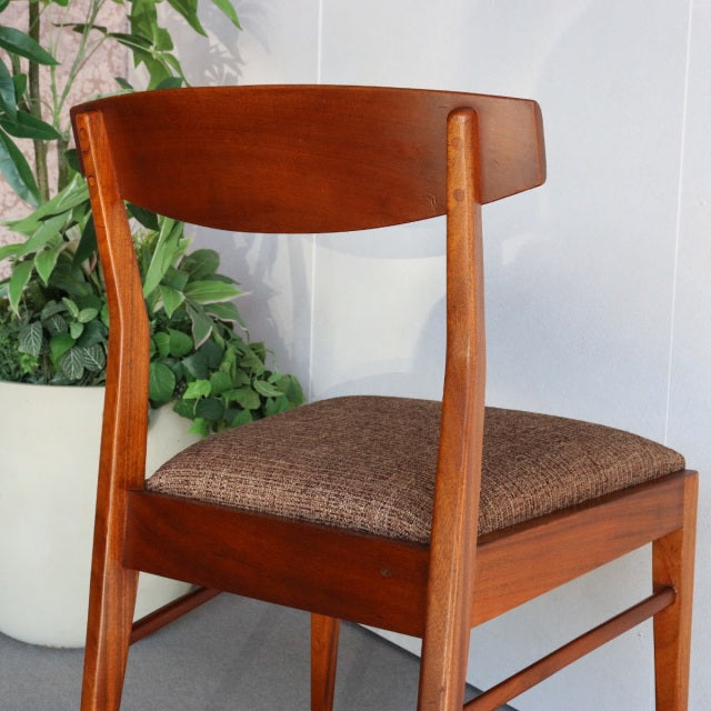Mid-century vintage British McIntosh teak dining chair with curved backrest, tapered legs, and brown upholstered seat cushion.