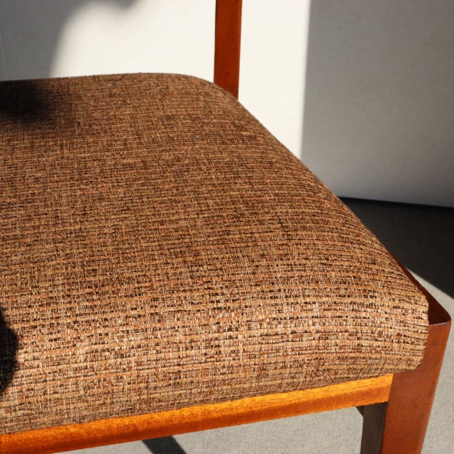 Mid-century British McIntosh dining chair with teak frame and textured brown vintage fabric seat.