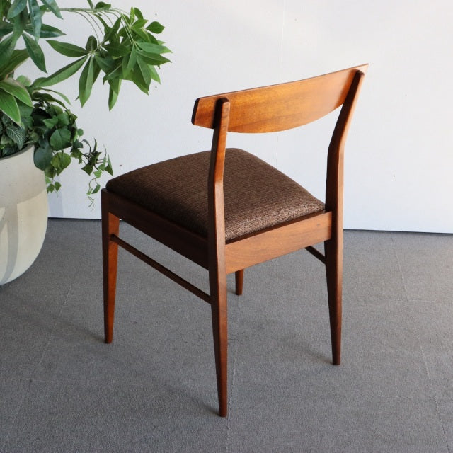 Vintage British mid-century teak dining chair by McIntosh with dark fabric seat and sleek tapered legs.