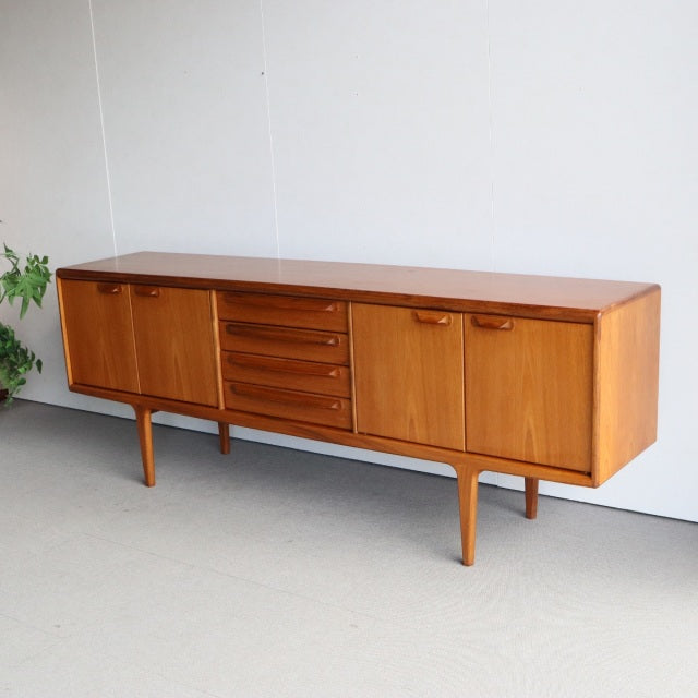 Vintage teak sideboard by Younger with mid-century British design, rich wood grain, and tapered legs.
