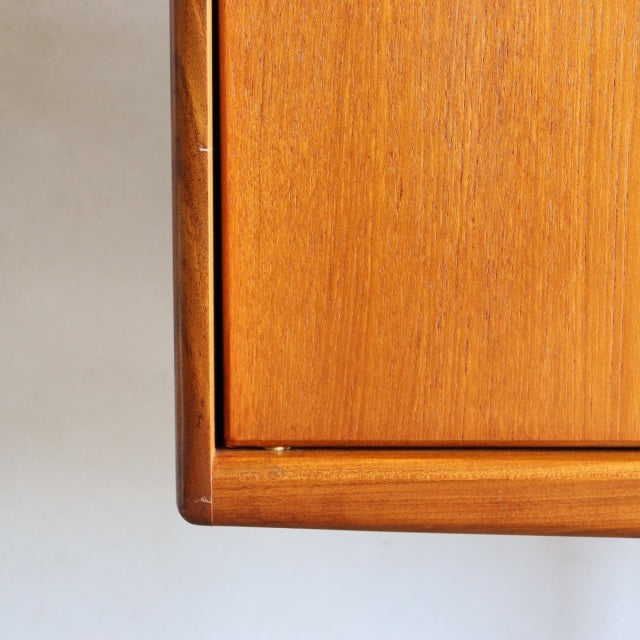 Close-up of vintage teak sideboard corner showing rich wood grain and smooth mid-century British craftsmanship from Younger.