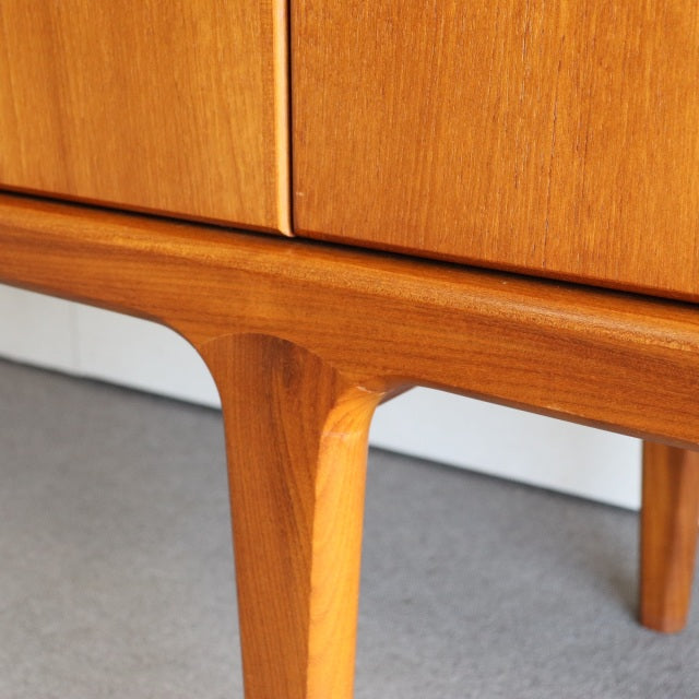 Mid-century British teak sideboard leg with smooth wood grain and tapered design, vintage Danish style.