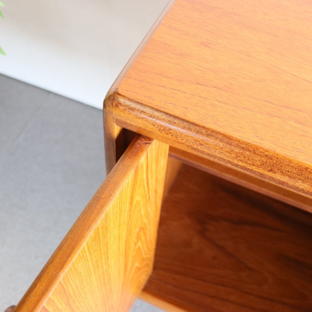 Close-up of vintage teak sideboard corner showing rich wood grain, smooth edges, and mid-century British design crafted by.