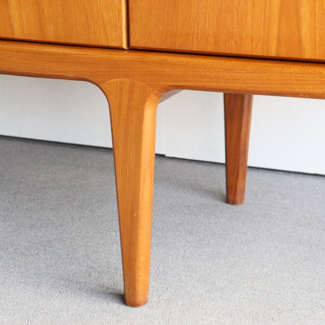 Mid-century British teak sideboard leg with smooth warm wood grain and tapered Scandinavian-style design from Younger.