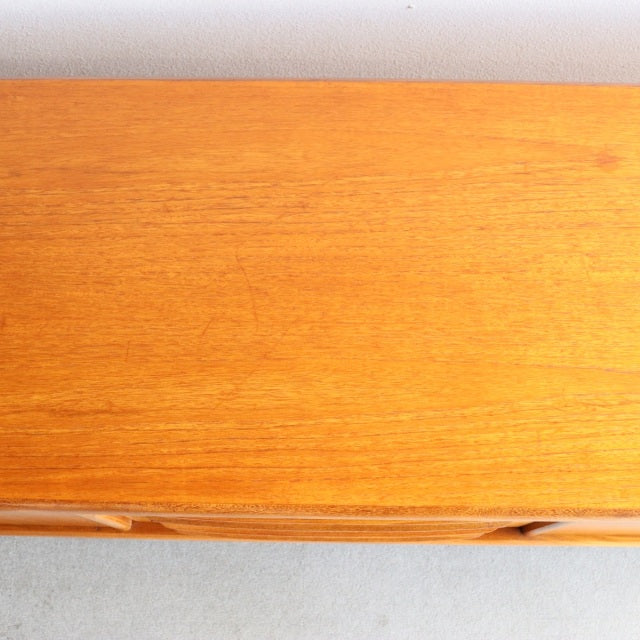 Close-up of vintage teak sideboard top with smooth grain, mid-century British design by Younger, Danish influence.