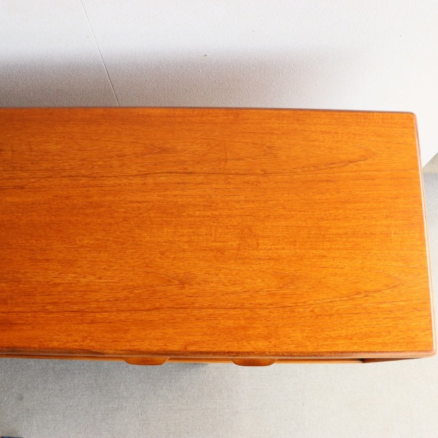 Vintage teak sideboard top surface showing warm wood grain, smooth finish, mid-century British design by Younger.