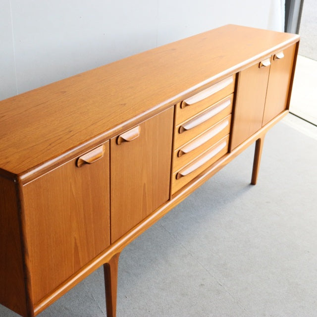 Mid-century British vintage teak sideboard by Younger with clean wood grain, tapered legs, and smooth drawer handles.