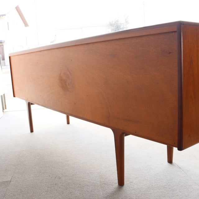 Mid-century British vintage teak sideboard by Younger with sleek grain, slender tapering legs, and clean rectangular form.
