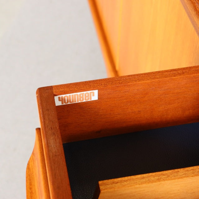 Close-up of vintage teak drawer interior with visible natural grain and Younger brand label on inner edge of mid-century.