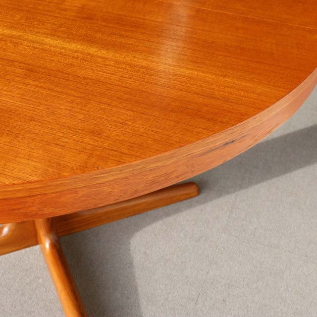 Round mid-century dining table in rich teak wood with smooth grain, featuring British-Denmark vintage design and slender.