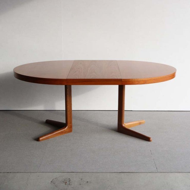 Vintage Edward Valentinsen teak round dining table with mid-century British Denmark design, curved legs and rich wood grain.