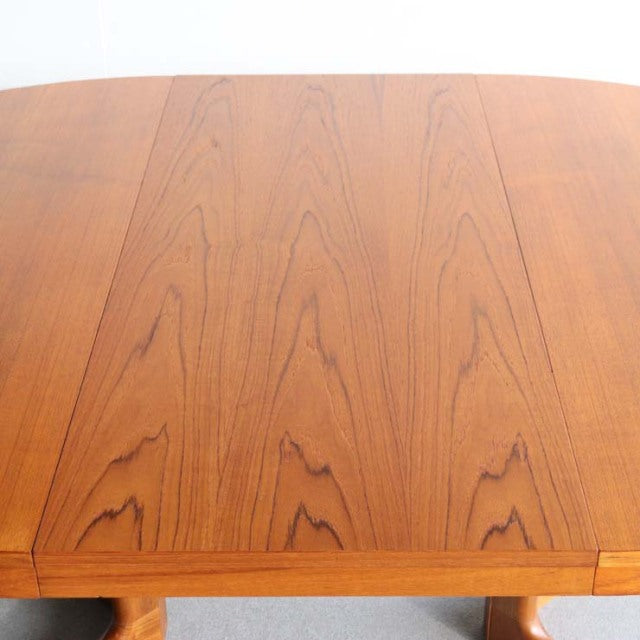 Round vintage teak dining table top with visible wood grain, mid-century British-Danish style.