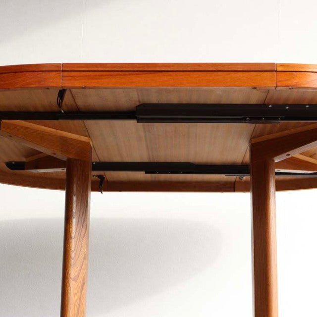 Vintage teak round dining table by Edward Valentinsen showcasing mid-century British Denmark design with smooth wood grain.
