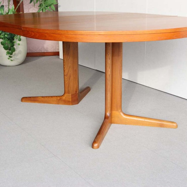 Vintage mid-century round teak dining table by Edward Valentinsen with smooth wood grain and splayed legs from Denmark.