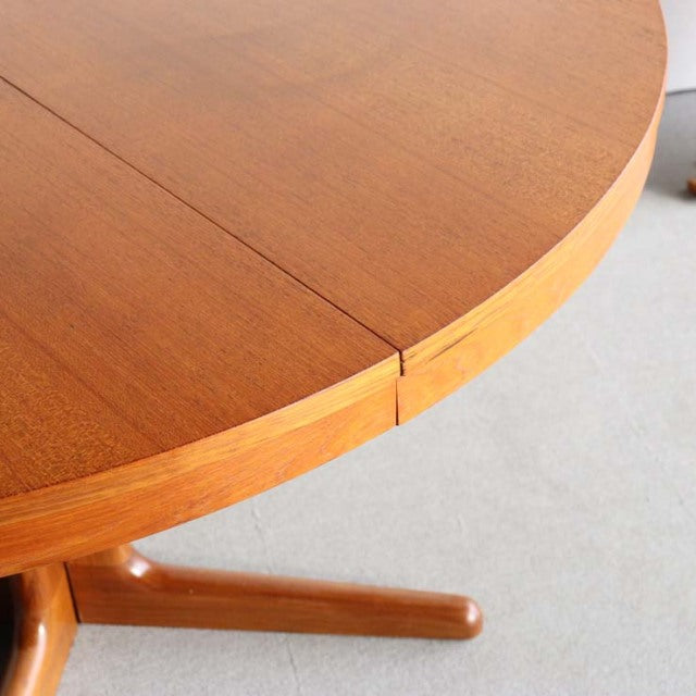 Round mid-century vintage teak dining table by Edward Valentinsen with smooth wood grain and British Scandinavian design legs.