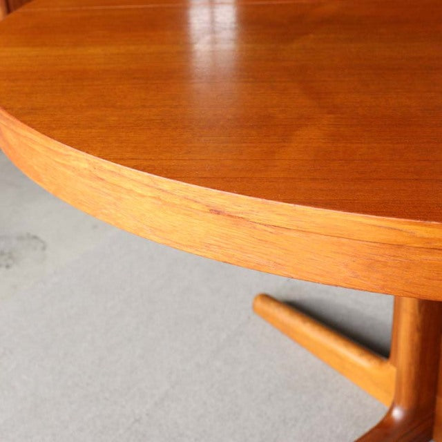 Vintage mid-century Edward Valentinsen teak round dining table with smooth wood grain and solid rounded legs from Denmark.