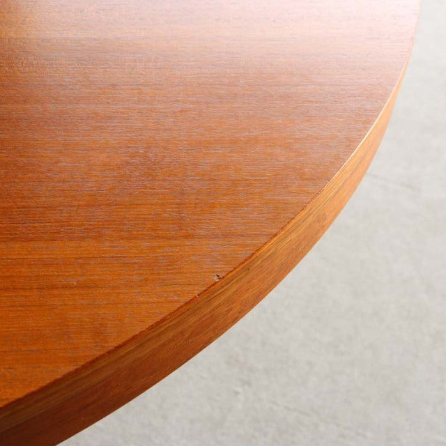Round vintage teak dining table top with smooth edges showcasing rich wood grain, mid-century British Denmark design.