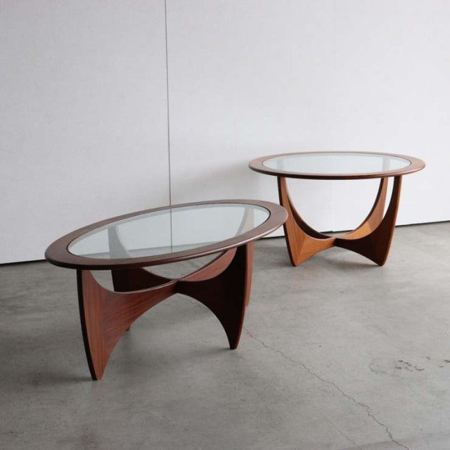 Pair of vintage British mid-century G-Plan Astrolround coffee tables with teak tripod bases and round glass tops.