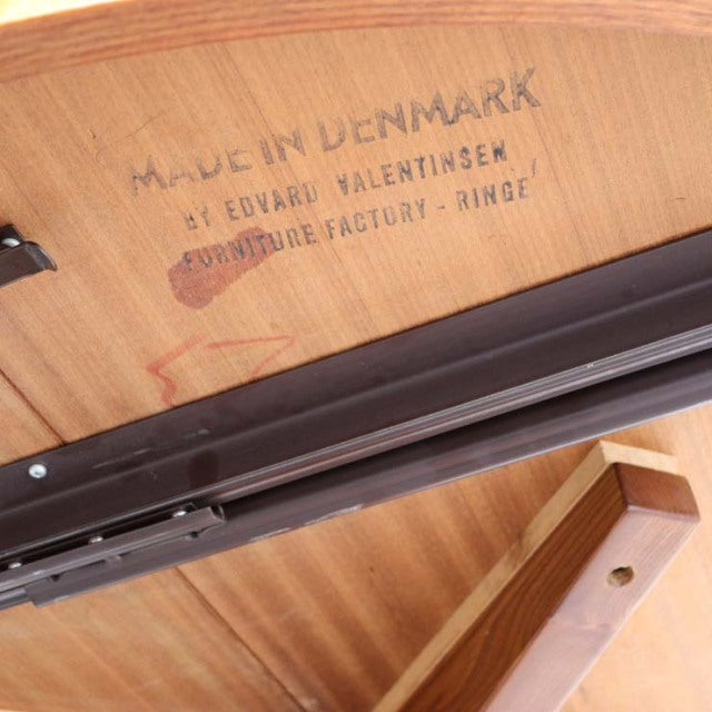 Close-up of teak underside with Edward Valentinsen branding and "Made in Denmark" inscription on vintage mid-century.