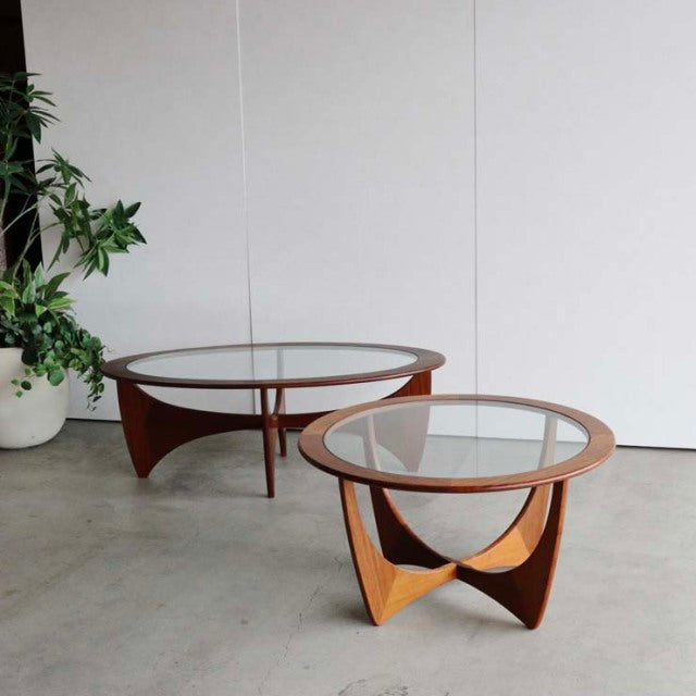 Pair of vintage G-Plan Astro Round teak coffee tables with glass tops, British mid-century design, sculptural wood grain.