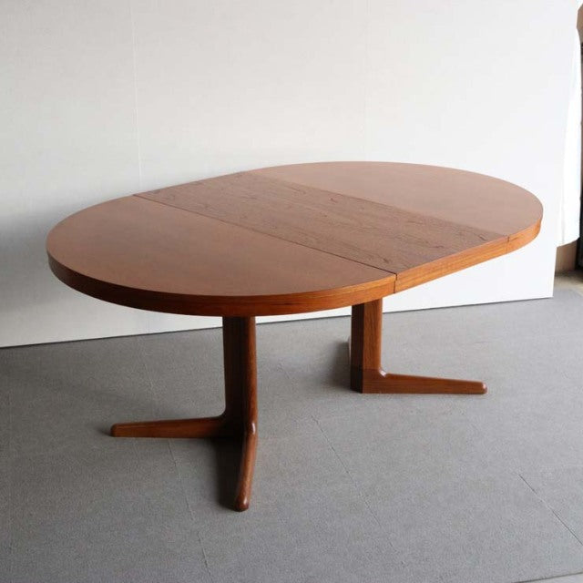 Vintage teak round dining table by Edward Valentinsen, British mid-century design with clean wood grain and sturdy angled.
