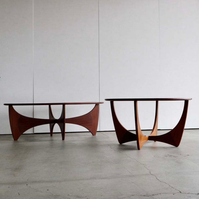 Vintage British mid-century G-Plan Astrolound coffee tables with teak bases and glass tops, showcasing curved legs and.