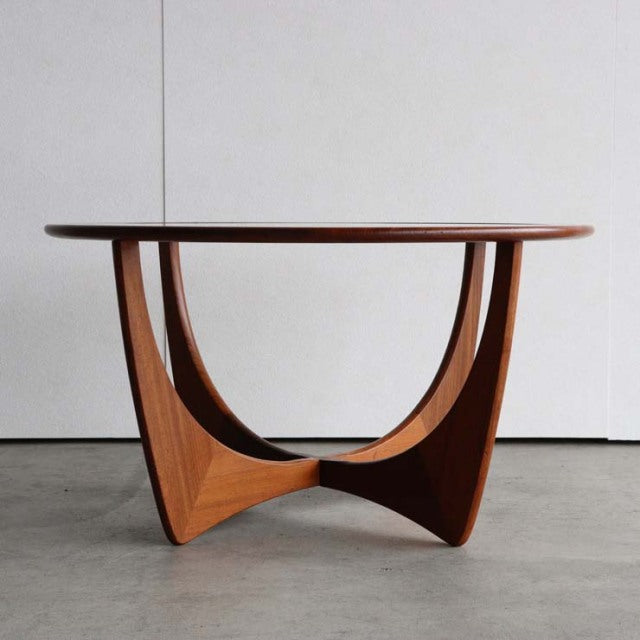 Vintage G-Plan mid-century teak coffee table with round glass top and sculptural British wood base.