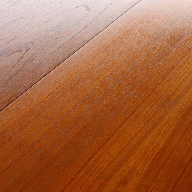 Close-up of vintage Edward Valentinsen teak dining table top showing warm wood grain with smooth mid-century finish.