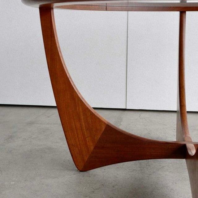 Vintage teak mid-century British G-Plan Astrolounge coffee table leg with smooth wood grain and curved design.