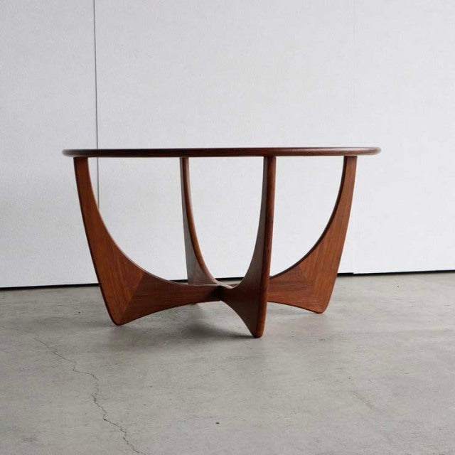 Vintage G-Plan mid-century teak coffee table with round glass top and sculptural British design legs.