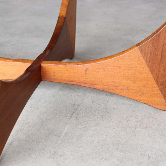 Close-up of vintage teak mid-century British G-Plan Astrolround coffee table leg with distinctive wood grain and smooth.