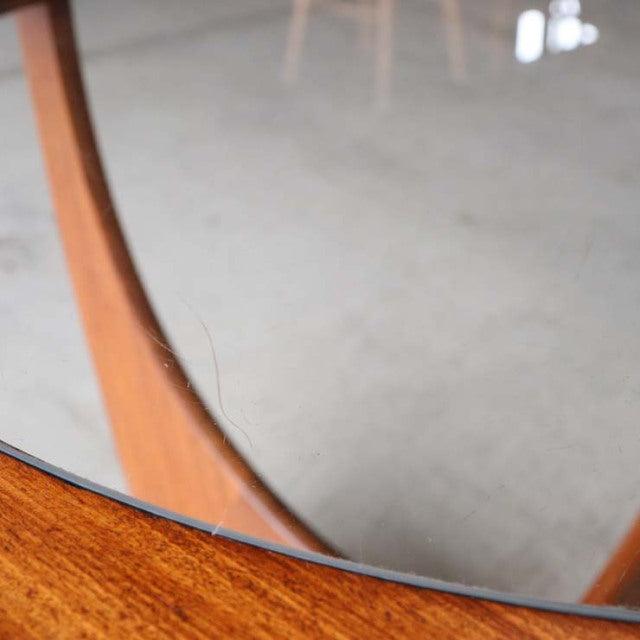 Vintage G-Plan British mid-century teak coffee table with round glass top and elegant curved legs.