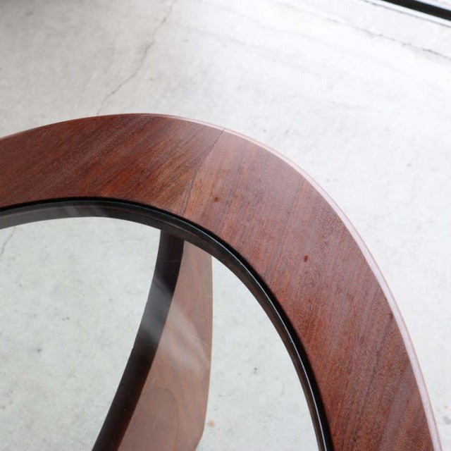 Oval mid-century British G-Plan coffee table with vintage teak frame and glass top, sleek tapered legs.