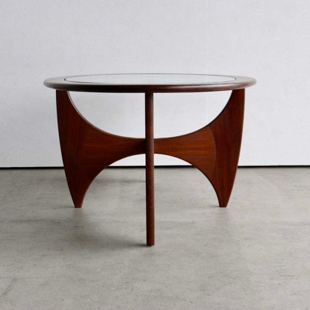 Vintage G-Plan mid-century British teak coffee table with oval glass top and sculpted curved legs.