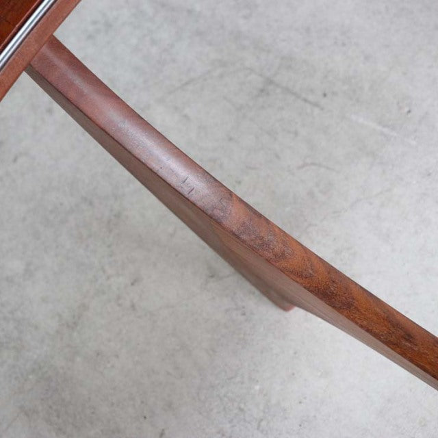 Close-up of vintage G-Plan teak coffee table leg showing smooth wood grain and mid-century British design details.