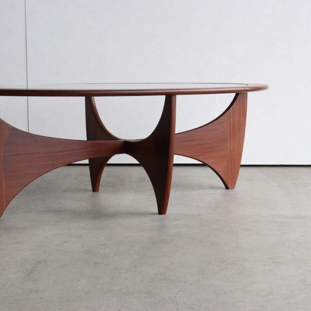 Mid-century British vintage G-Plan teak coffee table with oval glass top and sculpted wood grain legs.
