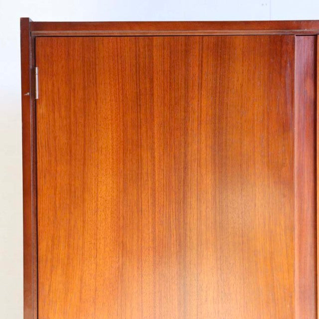 Mid-century British vintage teak cabinet by William Laurence with vertical wood grain and clean rectangular form.