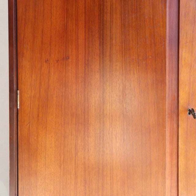 Vintage British mid-century teak cabinet door showing warm wood grain and smooth finish with subtle natural variations.